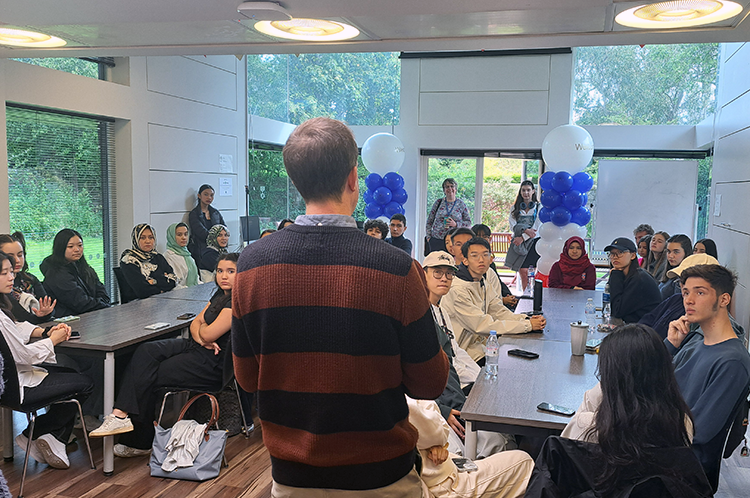 Prof. Eoin Jordan, with his back to camera, giving an introductory talk to a room of IFP students